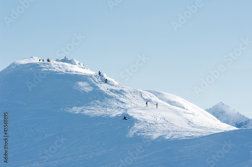 People on the snow-covered mountain peaks.