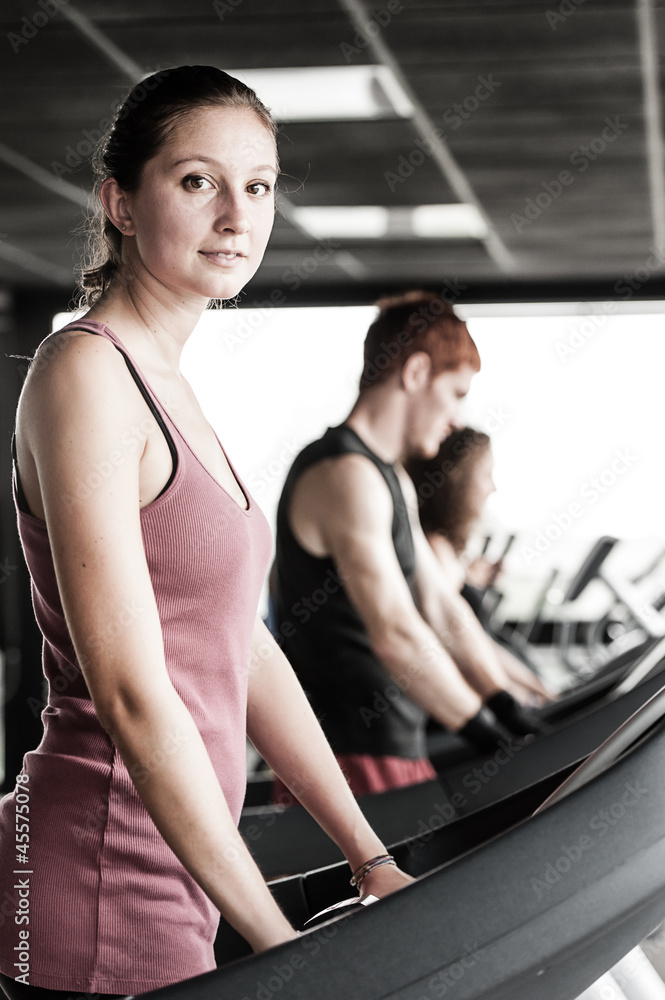 Running on treadmill in gym or fitness club - group of women and Running on treadmill in gym or fitness club - group of women and