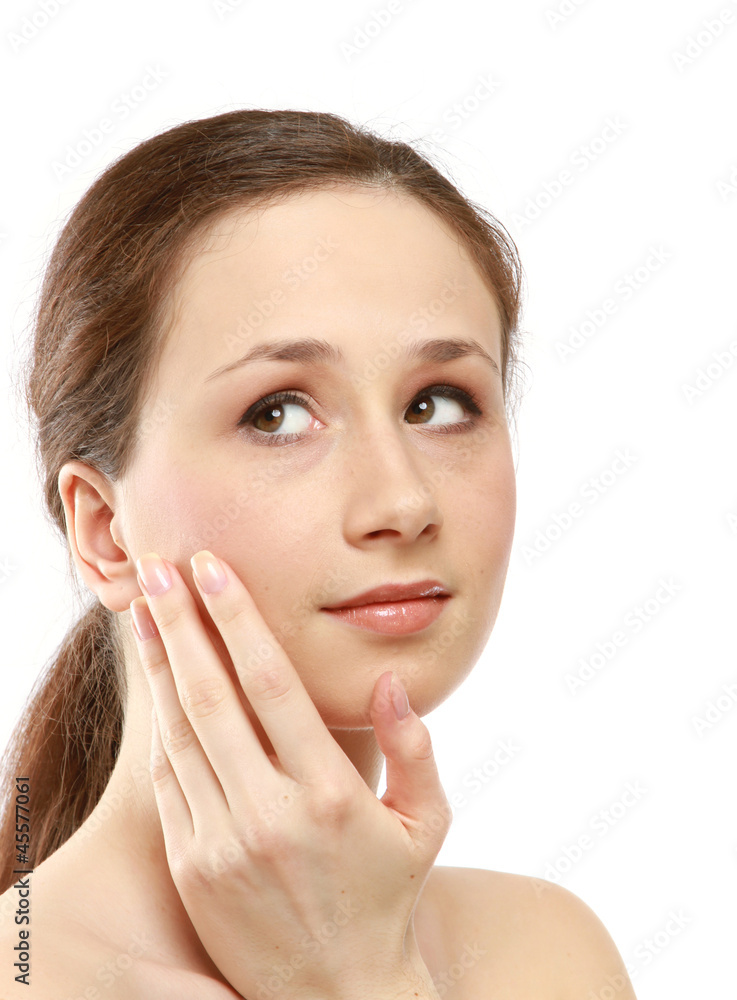A beautiful young woman touching her face