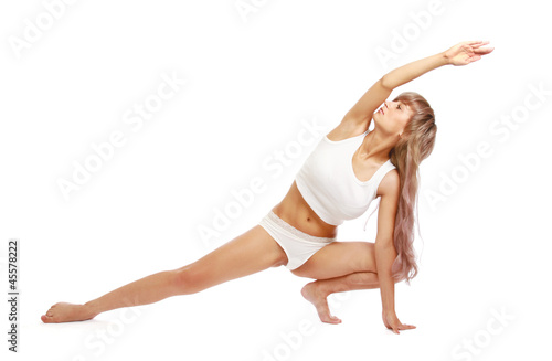 A young woman doing yoga, isolated on white
