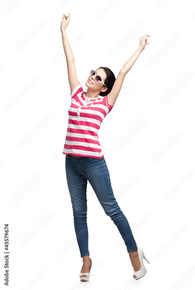 Happy dancing teenager with arms up, isolated. Fashion woman