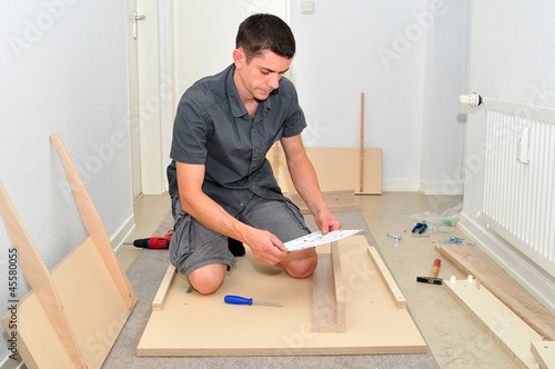 Man assembling a table.