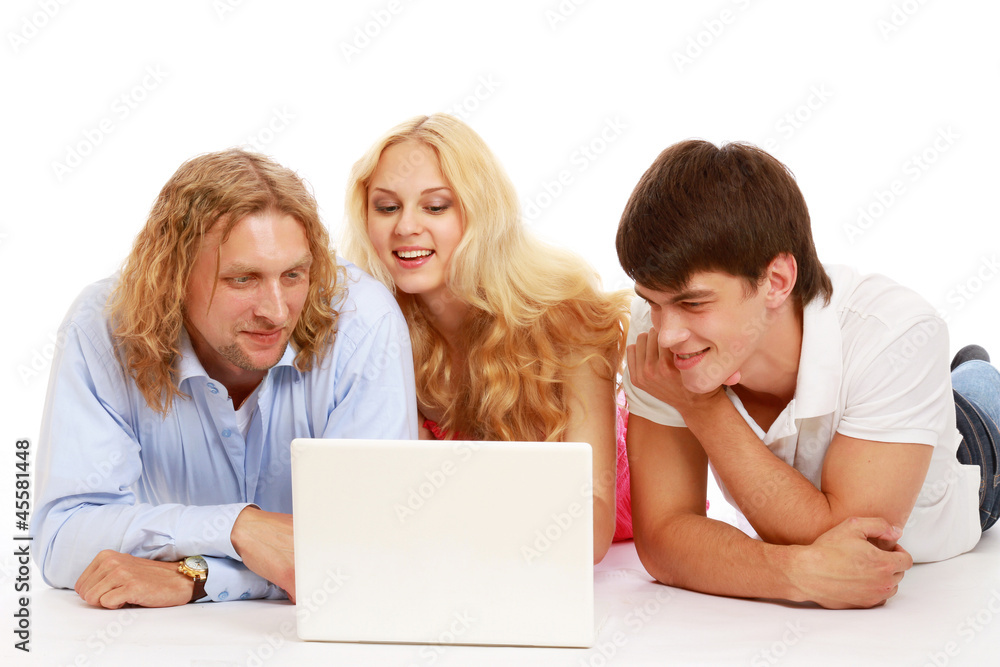 A group of happy young people lying A group of happy young people lying