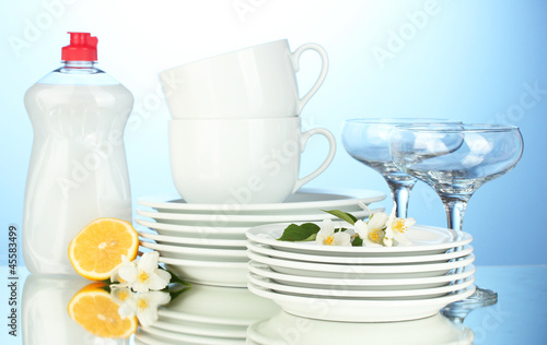 empty clean plates, glasses and cups with dishwashing liquid