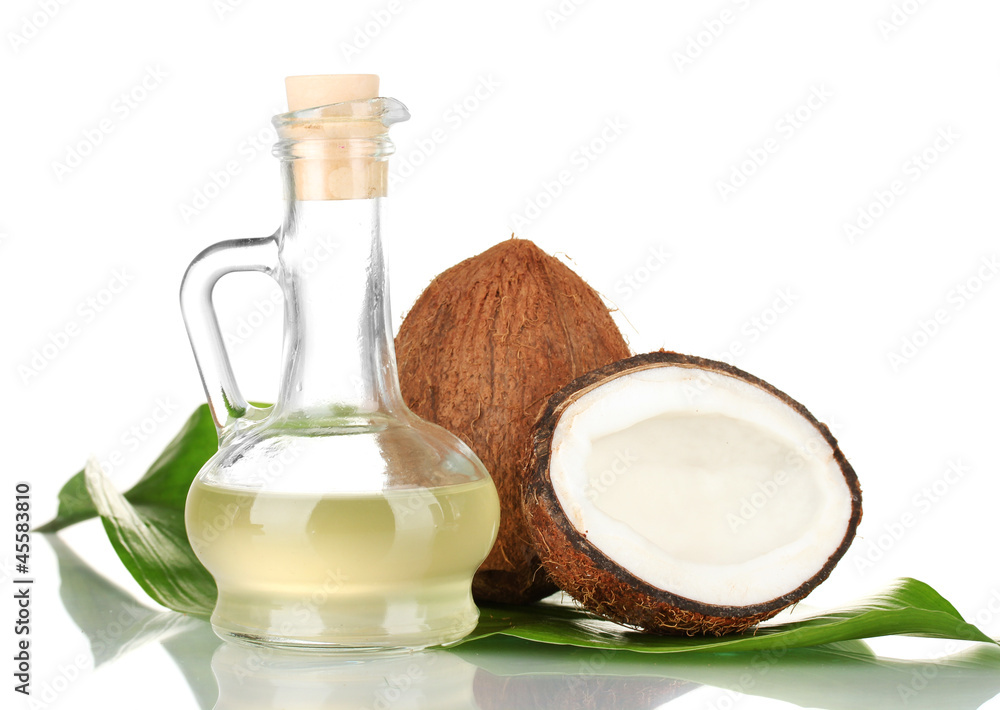 decanter with coconut oil and coconuts isolated on white
