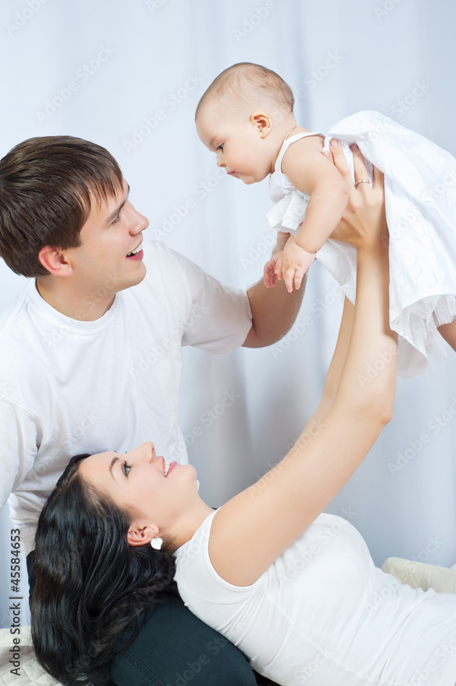 Happy family playing with a baby Happy family playing with a baby