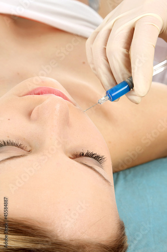 A young beautiful woman having an injection