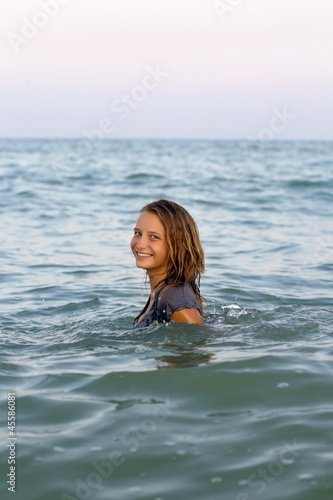 smiling teen girl in the sea © Sergey Sukhorukov