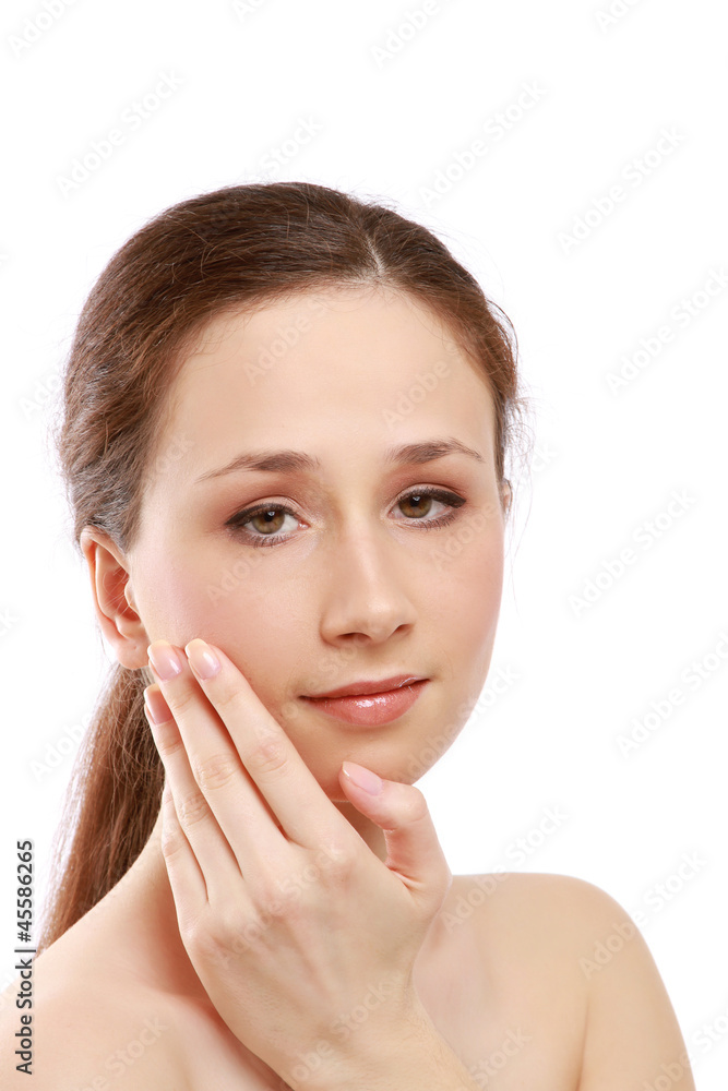 A beautiful young woman touching her face A beautiful young woman touching her face