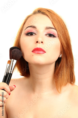 portrait of beautiful woman   with make-up brushes