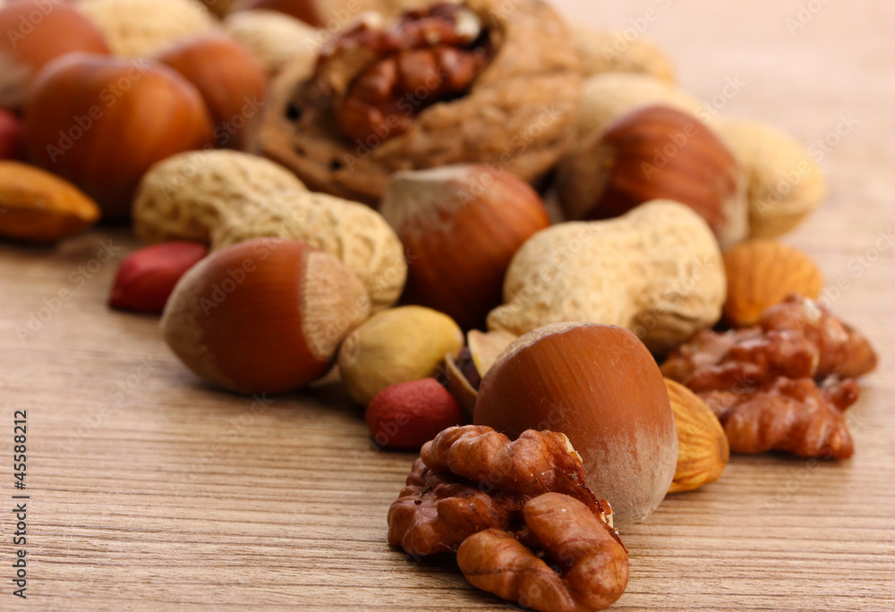 assortment of tasty nuts on wooden background assortment of tasty nuts on wooden background