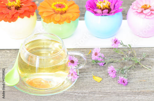 tea cup with different flowers on wood