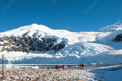 Red jacket expedition exploring Antarctica photo