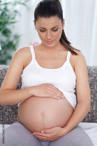 Pregnant woman stroking her tummy Free Download Pregnant woman stroking her tummy - GFXLoad