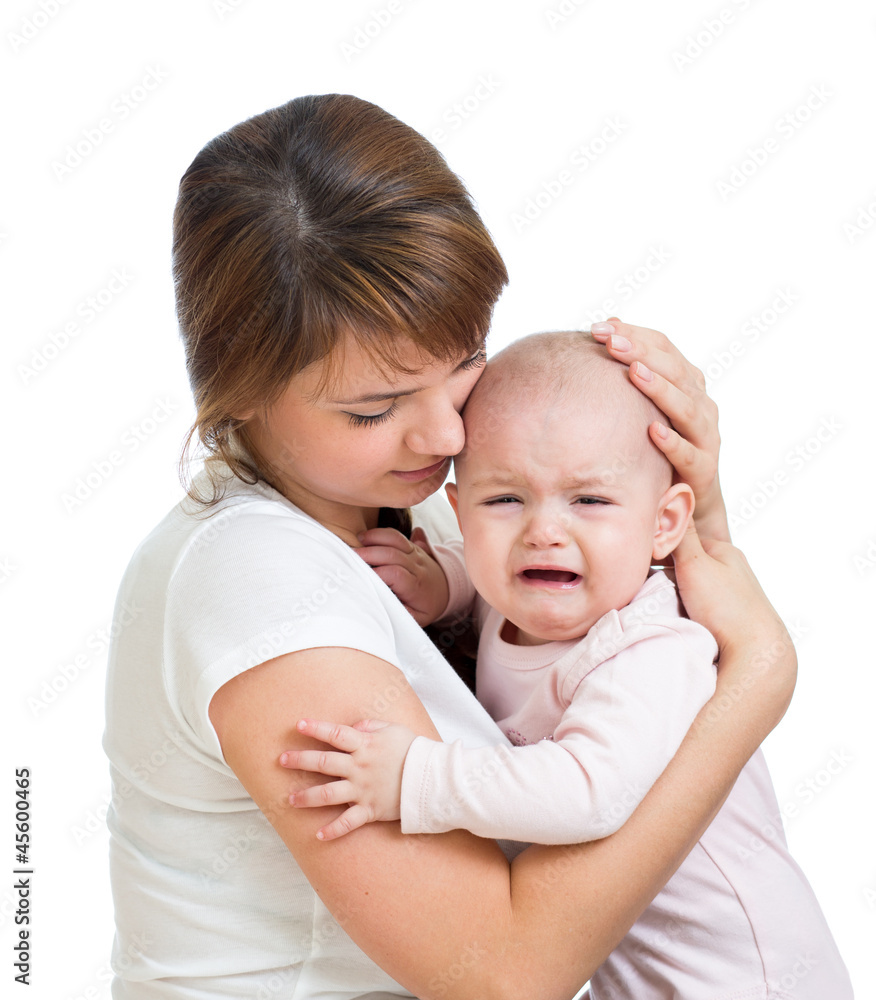 Mother calming her crying baby isolated Mother calming her crying baby isolated