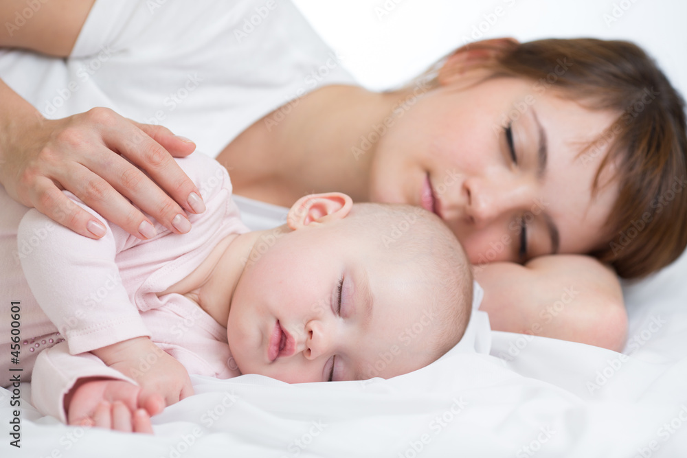 Young mother and her baby sleeping together Young mother and her baby sleeping together