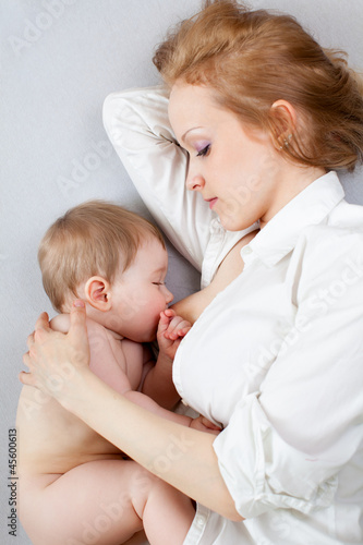 beautiful mother breast feeding her baby boy