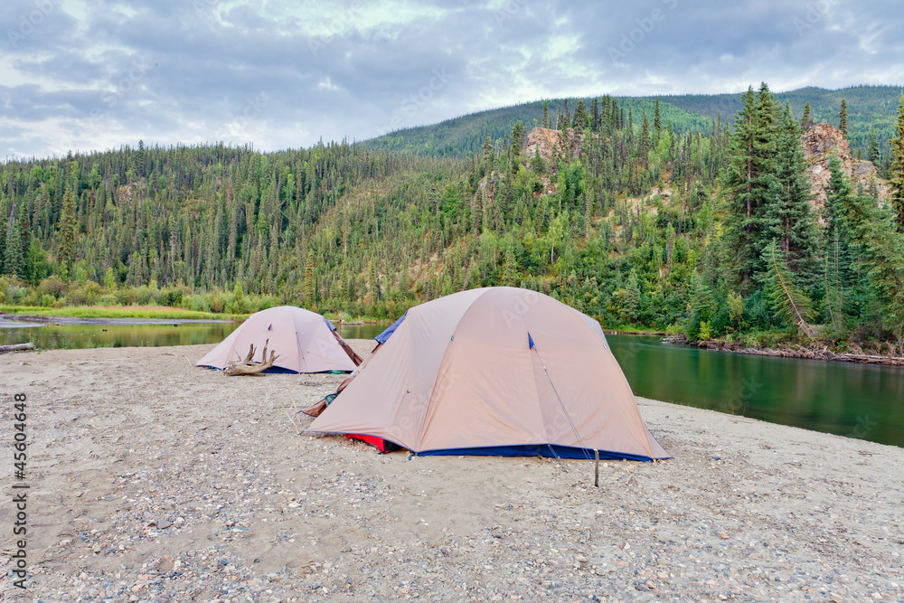 Tents at river in remote Yukon taiga wilderness