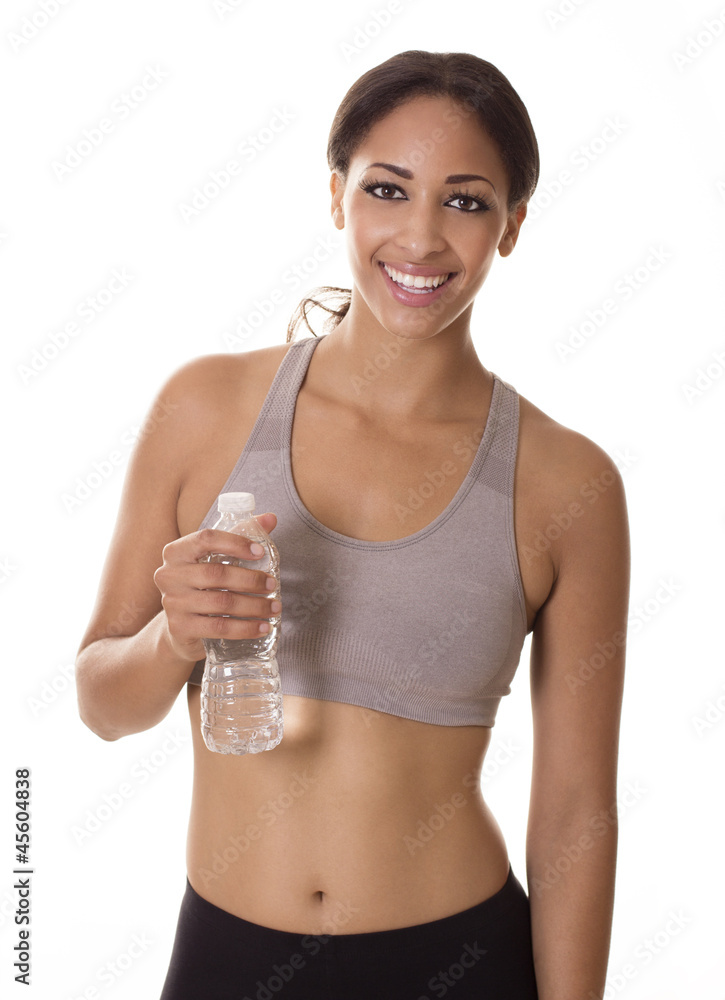 Beautiful woman smiles while holding a water bottle. Beautiful woman smiles while holding a water bottle.