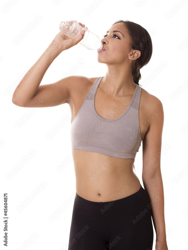 Fitness model drinks from a water bottle. Fitness model drinks from a water bottle.