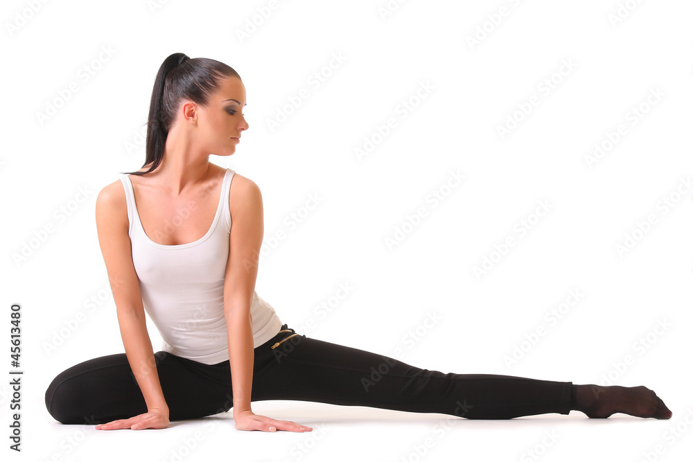 Flexible athletic woman stretching ,isolated white background Flexible athletic woman stretching ,isolated white background