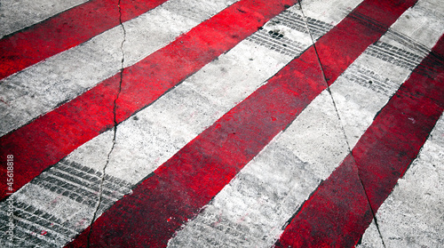 Red white stripes on the asphalt road