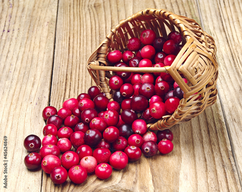 Cranberries near the basket Cranberries near the basket