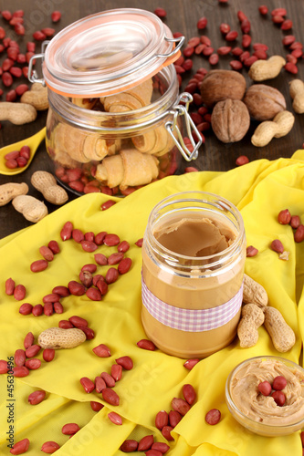 Delicious peanut butter in jar with baking