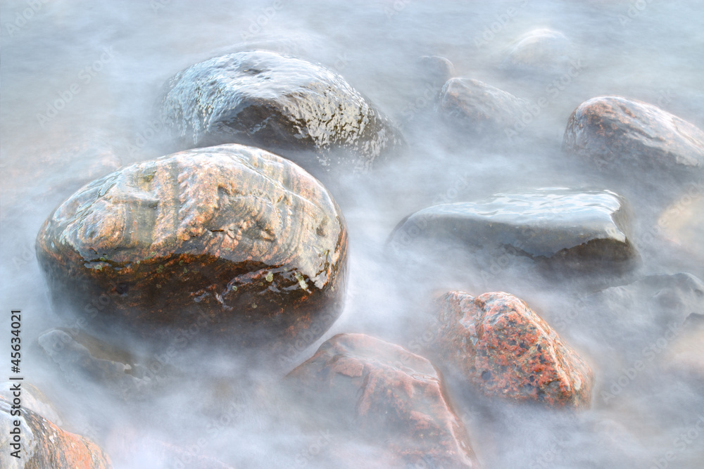 Closeup of sea water and beach rocks
