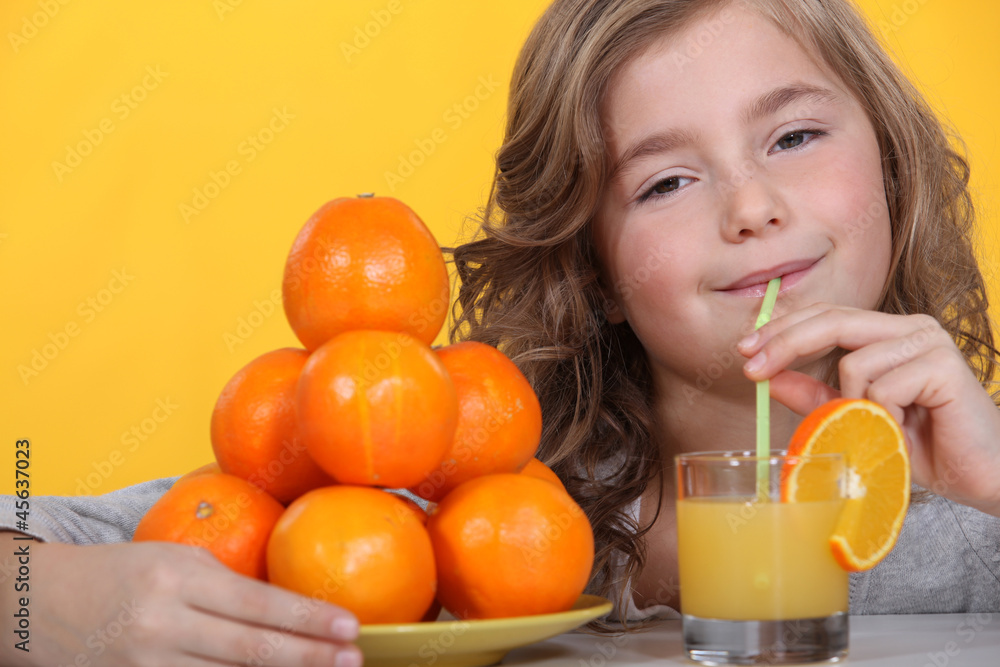 Little girl drinking freshly squeezed orange juice Little girl drinking freshly squeezed orange juice