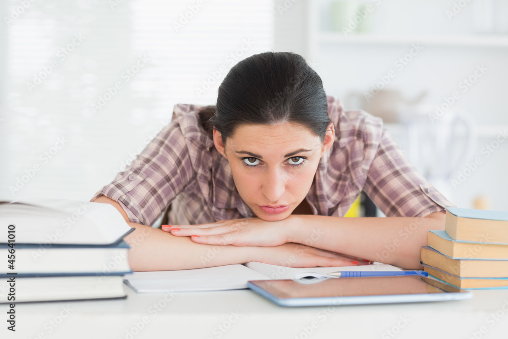 Woman leaning her chin on her hands on the table Woman leaning her chin on her hands on the table