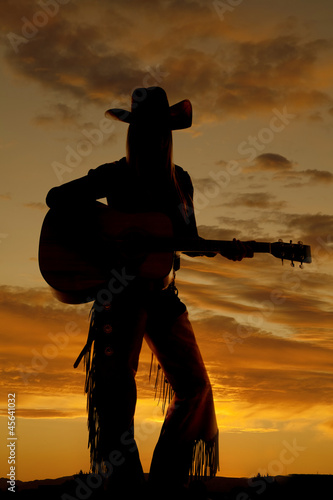 woman stand with guitar silhouette