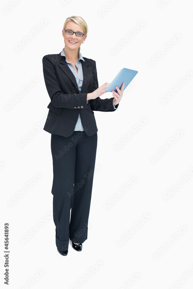 Smiling businesswoman using tablet pc Smiling businesswoman using tablet pc