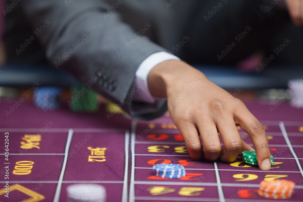Man in casino placing bet Man in casino placing bet
