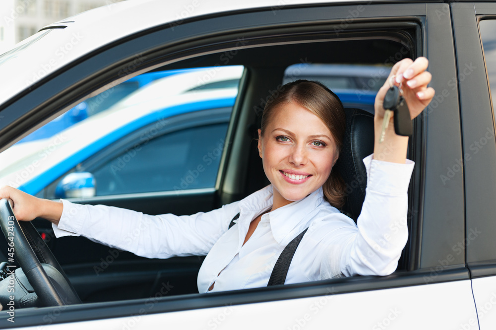 woman sitting in car and showing the car keys woman sitting in car and showing the car keys