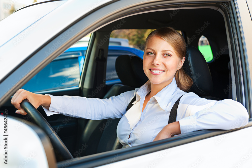 woman sitting in the car and smiling woman sitting in the car and smiling