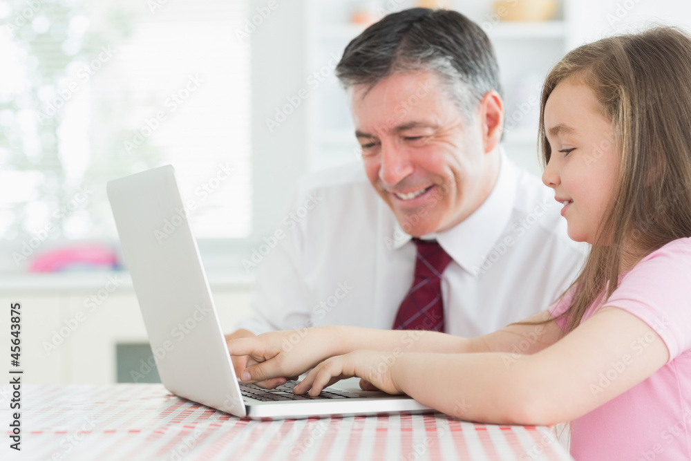 Girl typing with father watching Girl typing with father watching