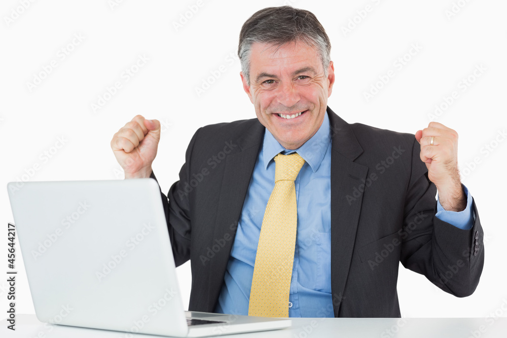 Succesful man sitting at his desk with laptop Succesful man sitting at his desk with laptop