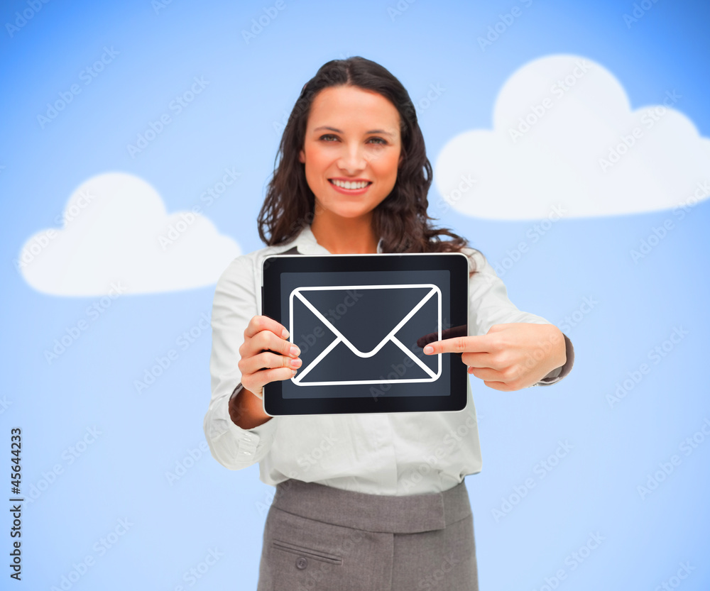 Businesswoman standing holding a tablet computer showing mail sy Businesswoman standing holding a tablet computer showing mail sy