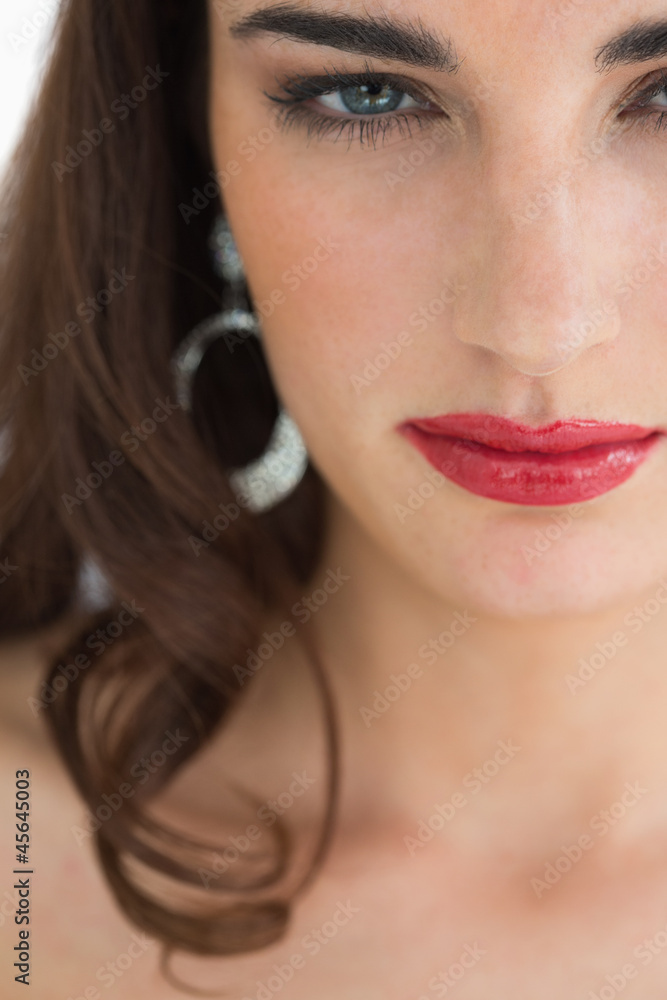 Woman wearing earrings staring at camera Woman wearing earrings staring at camera