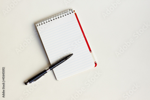 Photo pad and pen against white background