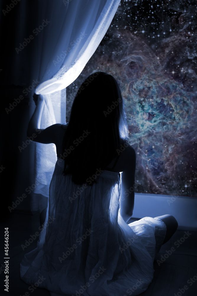 Young girl standing by the window, watching the stars Young girl standing by the window, watching the stars