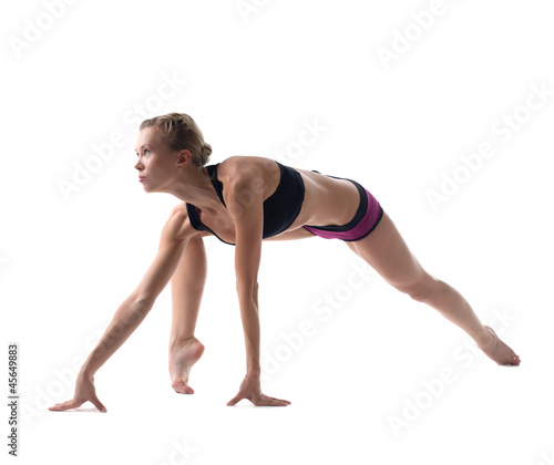 young blond woman doing split isolated