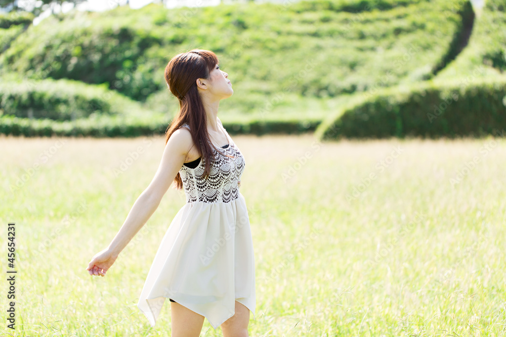 Beautiful young woman on green field. Portrait of asian. Beautiful young woman on green field. Portrait of asian.
