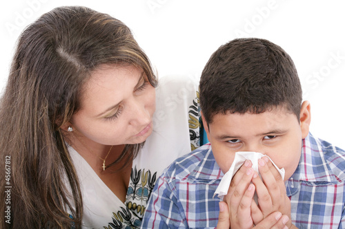 Child blowing nose. Child with tissue. catarrh or allergy