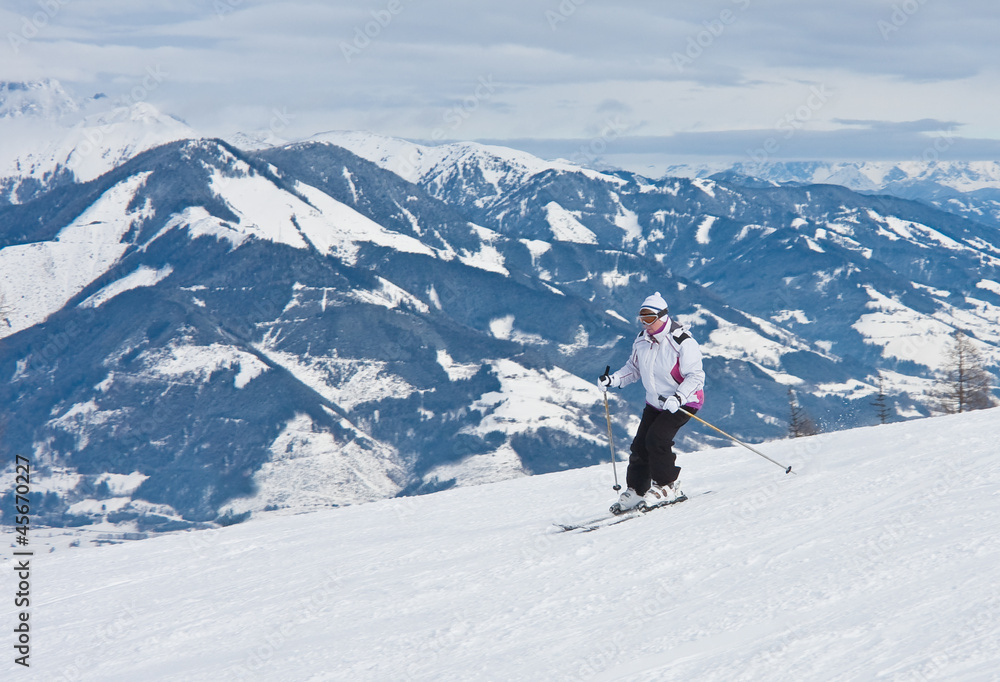 A woman is skiing at a ski resort