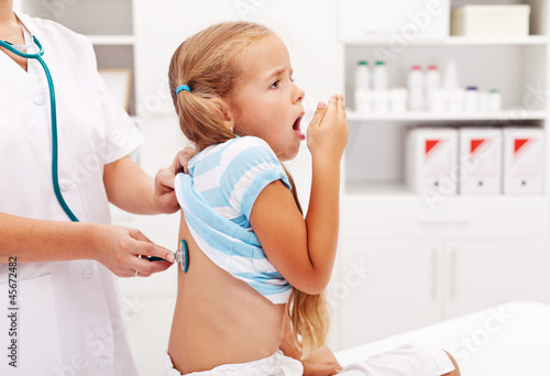 Fototapeta Little girl coughing at the doctor