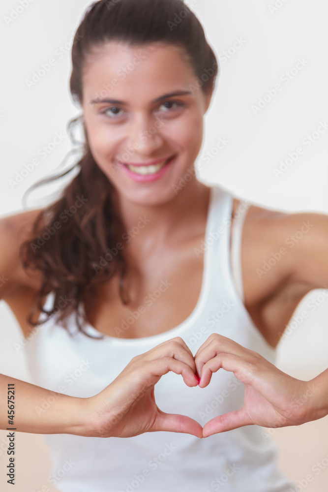 Young woman doing a heart with hands Young woman doing a heart with hands