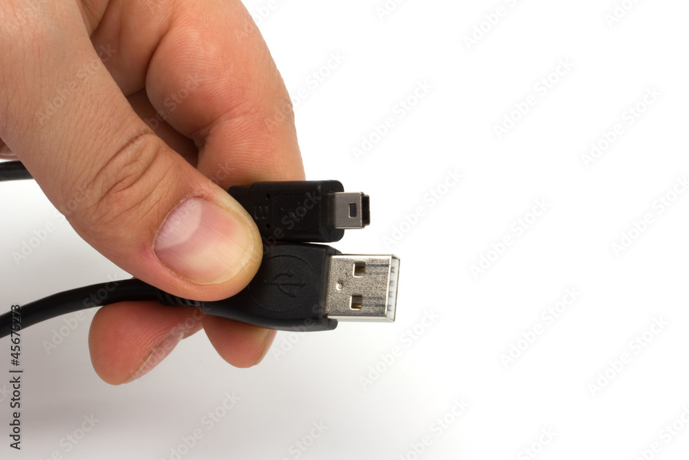 hand holding usb and mini-usb cable isolated on white background hand holding usb and mini-usb cable isolated on white background