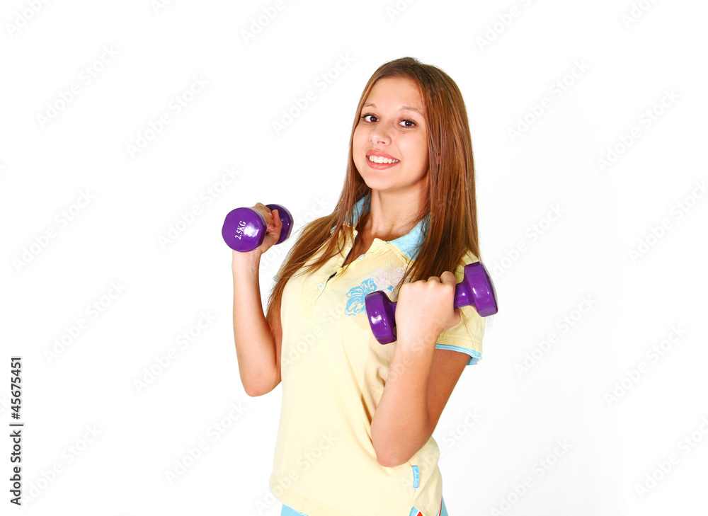 Smiling girl with purple dumbbells in shorts isolated on white b Smiling girl with purple dumbbells in shorts isolated on white b